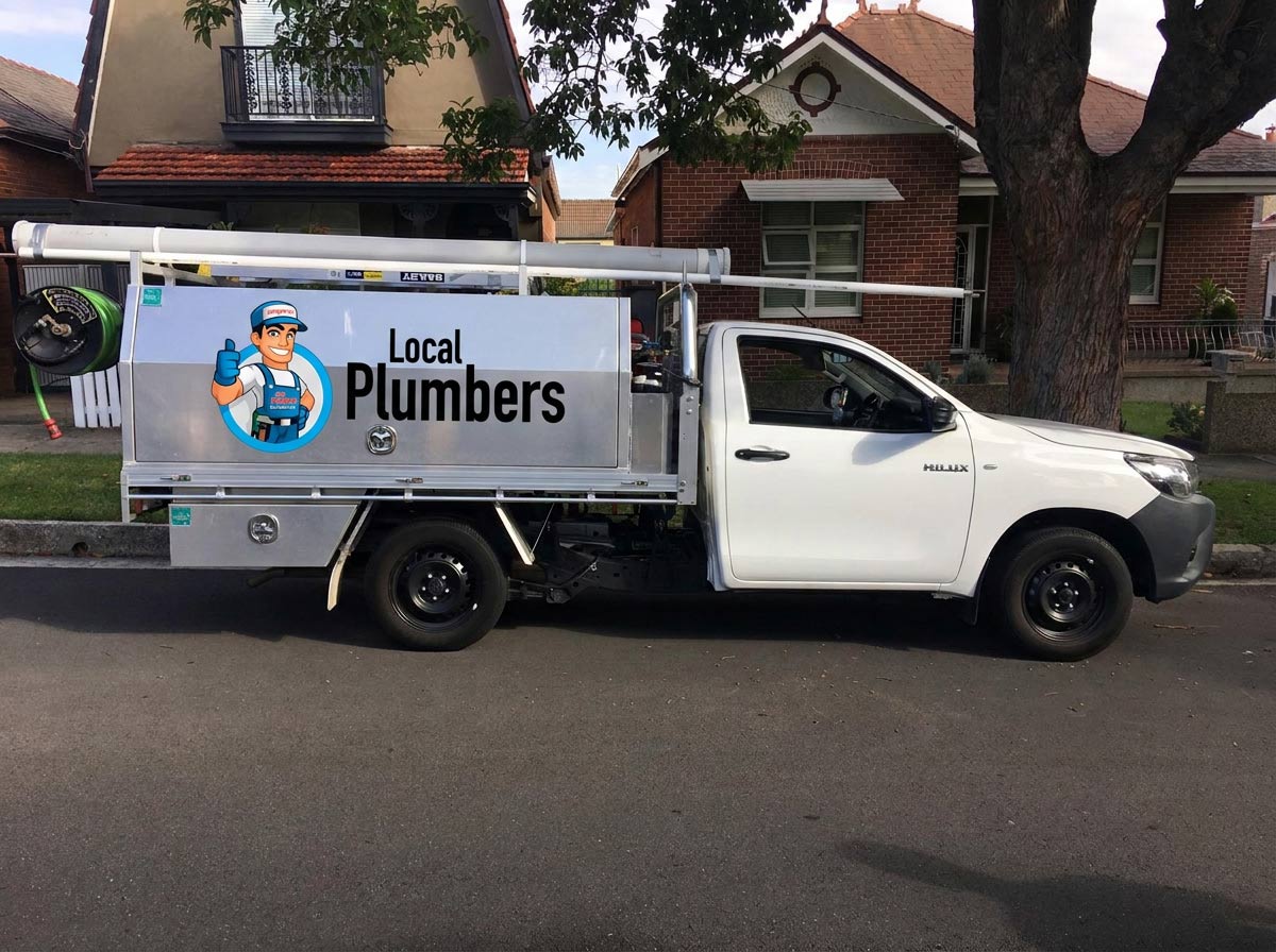Plumber inspecting a pipe in Strathfield